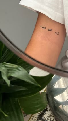 a woman's arm with the words two of us written on it