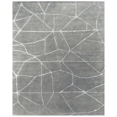 a gray rug with white lines on the top and bottom, in an abstract pattern