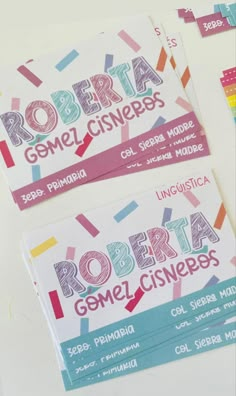 three business cards with different colored confetti on the front and back of them