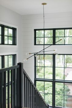 an open staircase leading to the upper level of a house with black and white walls