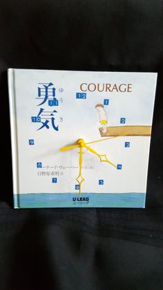 a clock made to look like a human hand with the words'courage'written on it