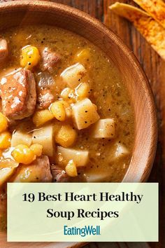 a wooden bowl filled with soup and potatoes