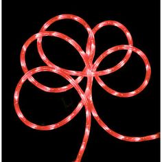 a red string light up the shape of a flower on a black background with white lights