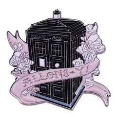 a badge with flowers on it and a police box in the middle, next to a ribbon