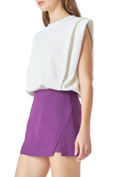 Padded shoulders lend plenty of drama to a sleeveless top completed by a ribbed waist. Crewneck Sleeveless, with padded shoulders 60% rayon, 30% nylon, 10% polyester Hand wash, dry flat Imported Fitted Tops With Padded Shoulders For Spring, Chic Tops With Padded Shoulders For Work, Spring Sleeveless Fitted Blouse, Sleeveless Fitted Blouse For Night Out, Elegant Spring Top With Padded Shoulders, Elegant Tops With Padded Shoulders For Spring, Chic Stretch Tank Blouse, Chic Tops With Padded Shoulders For Spring, Chic Spring Tops With Elastic Shoulders