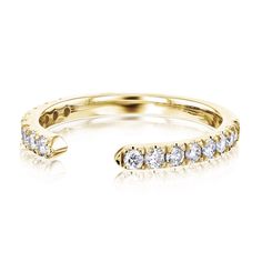 a yellow gold ring with five diamonds on the bottom and one diamond in the middle