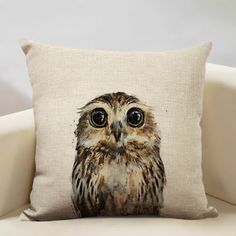 an owl pillow sitting on top of a couch