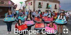 a group of young people holding up colorfully decorated items in front of a building