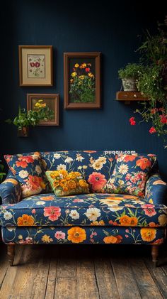 a blue couch with colorful flowers on it