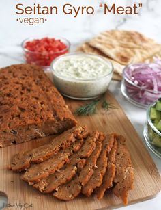 sliced meat and vegetables on a cutting board with the words seitan gyro meat