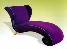 a purple chair sitting on top of a white floor