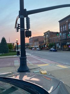 a street light sitting on the side of a road next to a traffic light pole