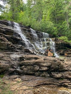 a waterfall in the middle of a forest