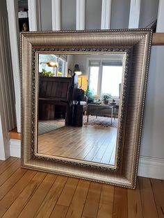 a mirror sitting on top of a hard wood floor