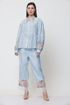 Blue shirt with placed floral thread embroidery, pleated bodice and pearl embellishments. Comes with embroidered pant. - Aza Fashions Spring Embroidered Sets With Straight Pants, Embroidered Spring Sets With Straight Pants, Spring Sets With Embroidered Straight Pants, Spring Straight Pants With Resham Embroidery, Straight Pants With Resham Embroidery For Spring, Long Sleeve Sets With Embroidered Hem For Spring, Floral Embroidered Pants For Spring Workwear, Floral Embroidered Bottoms For Spring Daywear, Spring Cotton Pants With Resham Embroidery