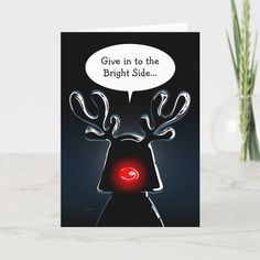 a greeting card with an image of a reindeer's head and the words give in to the bright side