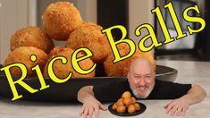 a man sitting at a table with some food in front of him and the words rice balls