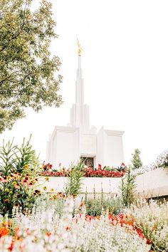 the temple is surrounded by flowers and trees