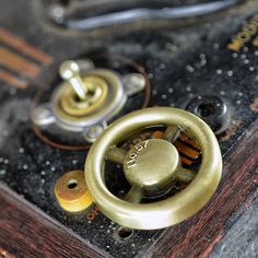 an old wooden box with metal knobs on it