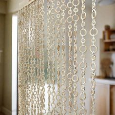 the curtains are hanging from the ceiling in the living room or kitchen, which is decorated with rings and circles