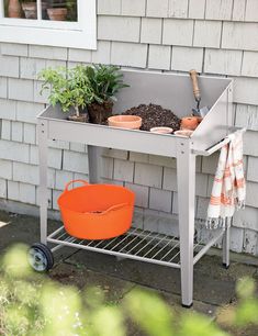 an outdoor potting station with pots and plants