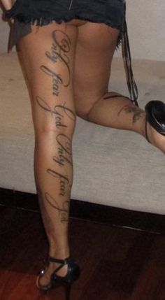 a woman with tattoos on her legs and heels