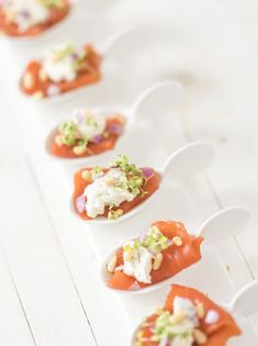 small appetizers are lined up on white plates