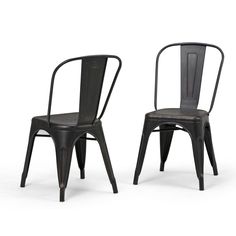 two black metal chairs side by side on a white background with one chair facing the other