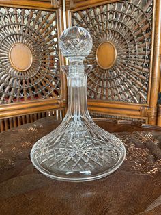 a glass vase sitting on top of a wooden table