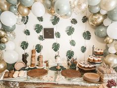 a table with desserts and balloons on it