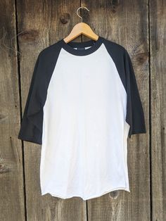 Classic Y2K raglan tee, early 2000s vintage. A flattering and comfy oversize t shirt, in a cool black & white two-tone. Great as retro athletic wear, or everyday casual. Brand : EASTON 60% cotton, 40% polyester Labeled size L I'd say fits like a Men's L, Ladies' XL All measurements taken with garment lying flat, double where necessary roughly 17 inches shoulder to shoulder 21 inches pit to pit 21 inches across hem 28 inches from neckline to hem 15 inch sleeve length Very good vintage condition. Black Cotton Baseball Jersey With Letter Print, Black Cotton Sporty Baseball Jersey, White Cotton Baseball Jersey For Baseball Season, White Cotton Baseball Jersey, White Cotton Tops With Baseball Collar, Cotton Tops With Contrast Sleeves For Streetwear, Cotton Top With Contrast Sleeves For Streetwear, White Pre-shrunk Short Sleeve Baseball Jersey, White Cotton Sporty Baseball Jersey