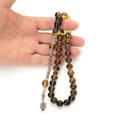 Unique and one-of-a-kind Islamic rosary beads, made of genuine Baltic amber. In amber visible inclusions of ancient nature and fauna which more than 40 million years. Collectible original rosary beads. The tasbih is carved from genuine amber stones. Amber tasbih are assembled on a high quality thread with a unique tassel of individual design, handmade. The rosary looks flawless and will be a wonderful accessory that conveys the natural energy and warmth of amber. Tasbih gives an incredibly pleasant feeling. This special Islamic rosary will make a wonderful gift for you and your loved ones. Weight rosary: 35 g Size Amber Beads: 0,43 in(11mm)  Imam size: 1,4 in(35 mm) Length rosary with imam: 9 in(23 cm) Looking for a Meaningful Gift - this is an excellent choice! For a gift for the love of Spiritual Amber Beads For Jewelry Making, Amber Spiritual Round Beads, Round Amber Beads Gems And Cabochons For Gifts, Round Amber Beads, Gems, And Cabochons For Gifts, Round Amber Beads And Cabochons For Gifts, Amber Beads And Cabochons For Gift, The Rosary, Natural Amber, Rosary Beads