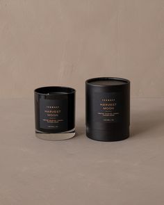 two black candles sitting next to each other