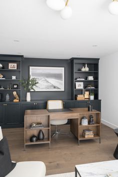 a home office with built in bookcases and shelves