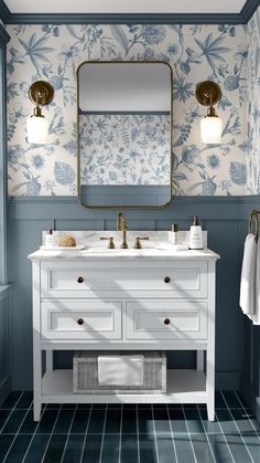 a bathroom with blue walls and white furniture