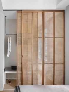 a bedroom with wooden sliding doors and white walls