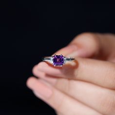 Product Details This Solitaire Ring is embellished with a 6 MM Asscher Cut Amethyst secured in Claw Setting, flanked by Baguette Cut Diamonds in Prong Setting. • Grab this unique and versatile Natural Amethyst Ring for your special ones like your wife, mom, sister, or girlfriend, and wait for their priceless reaction. Product Information SKU SHP-RINGS072210060 Weight 2.08 gm (Approximate) AMETHYST INFORMATION No.of Stones 1 Pieces Total Weight 1.35 Carat (Approximate) Dimension(approx) Asscher-6 Asscher Cut Birthstone Ring With Prong Setting, Brilliant Cut Amethyst Ring As Gift, Fine Jewelry Diamond-cut Amethyst Ring As Gift, Elegant Purple Asscher-cut Ring, Asscher-cut Ruby Gemstone Ring, Claw Setting, Asscher Cut, Baguette Cut Diamond, Ring With Diamond