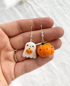 Halloween Pumpkin and ghost earrings, Halloween Best Friends Gift, Trick or treat Halloween earrings, Pumpkin earrings, Ghost earrings . Mismatched earrings with one pumpkin and one ghost The charms measure about 2 cm and are made by hand from polymer clay. Since we do not use molds or forms, the models may slightly vary from the picture. Please select the hooks material you prefer from below: sterling silver 925 or stainless steel. * Each product comes in a cute packaging. * Visit our shop to s Diy Ghost Earrings, Cute White Halloween Earrings, Ghost Clay Earrings, Cute Orange Earrings For Halloween, Cute Orange Halloween Earrings, Cute Ghost Earrings, Novelty Halloween Earrings, Pumpkin And Ghost, Ghost Earrings