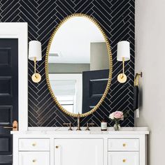 a black and white bathroom with gold accents