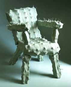 a chair made out of wood with nails on it