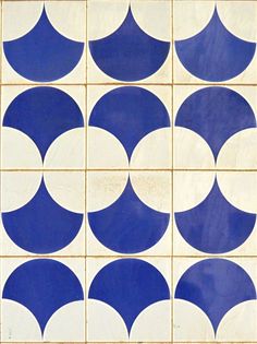 a blue and white tile with circles on the bottom, in different directions to make it look like they have been made out of ceramic tiles