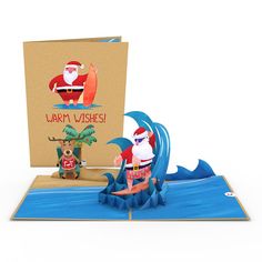 a christmas card with santa on the surfboard and an ornament next to it