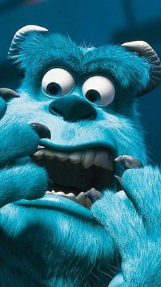 an evil looking blue monster with big eyes and claws on his face, staring at the camera