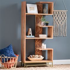 a wooden shelf sitting on top of a carpeted floor next to a blue wall