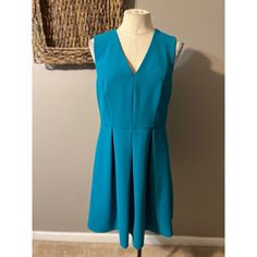 This Pretty Dress Is From Draper James In A Misses Size . Solid Blue/Green In Color. Soft And Stretchy, Made Of 96% Polyester And 4% Spandex. Polyester Lining. Has An A Line Fit With Back Zipper. There Are Hidden Hip Pockets. Machine Washable. Unstretched, Measured From Seam To Seam Across The Front: Bust Is 18 Inches Across Waist Is 16 Inches Across Hips Are 20.5 Inches Across Length Is 36.5 Inches Long New Without Tags. From A Smoke Free Home. Thanks For Shopping With Me. Blue V-neck Pleated Mini Dress, Blue Pleated V-neck Mini Dress, Blue Pleated Mini Dress For Work, Elegant Turquoise Mini Dress For Spring, Draper James, Pretty Dress, Thanks For Shopping, Dress Blue, Pretty Dresses