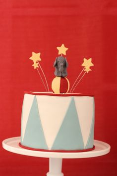 a cake decorated with stars and a dog figurine on top