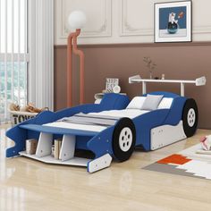 a child's bedroom with a blue race car bed