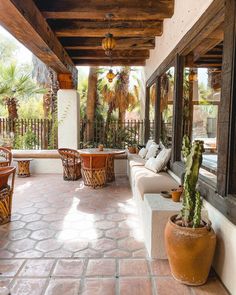 an outdoor patio with seating and potted plants