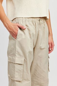 Cargo pants featuring a relaxed fit, side pockets and elastic around waist. The fun pants work for any season. Pair them with a sweater or a simple tee for an effortlessly chic look! Model is 5.9, wearing size S. Recommended sizing 2-4 S, 6 M, 8-10 L Pants With Elastic Waist, Dusty Sage, Athleisure Tops, Nylon Pants, Simple Tee, Black Knit Dress, Cardigan Sweater Coat, Fun Pants, Denim Outerwear