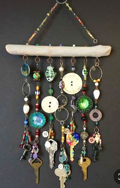 a surfboard hanging on the wall with lots of keychains and buttons attached to it